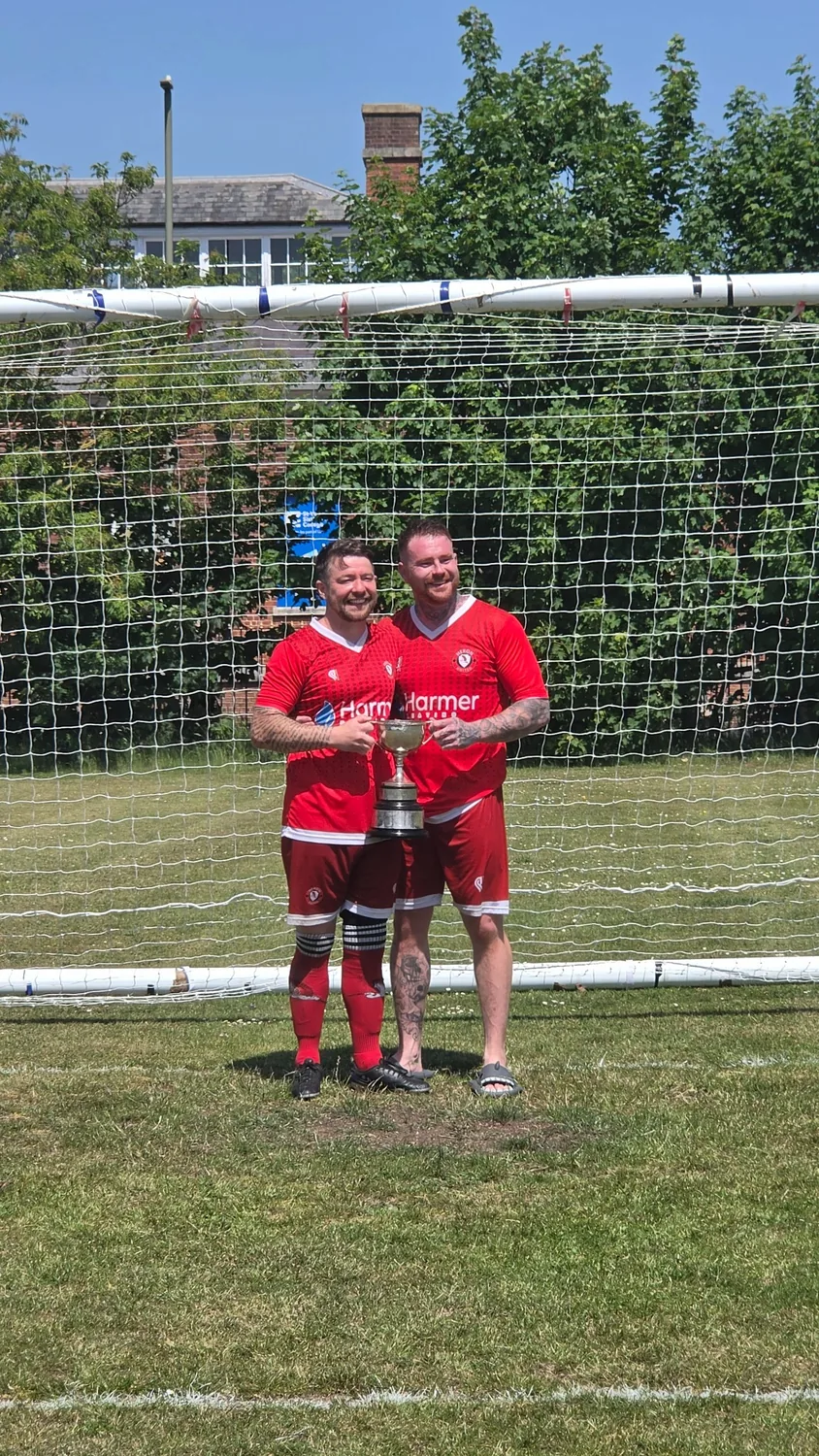Heron United players celebrating with the trophy