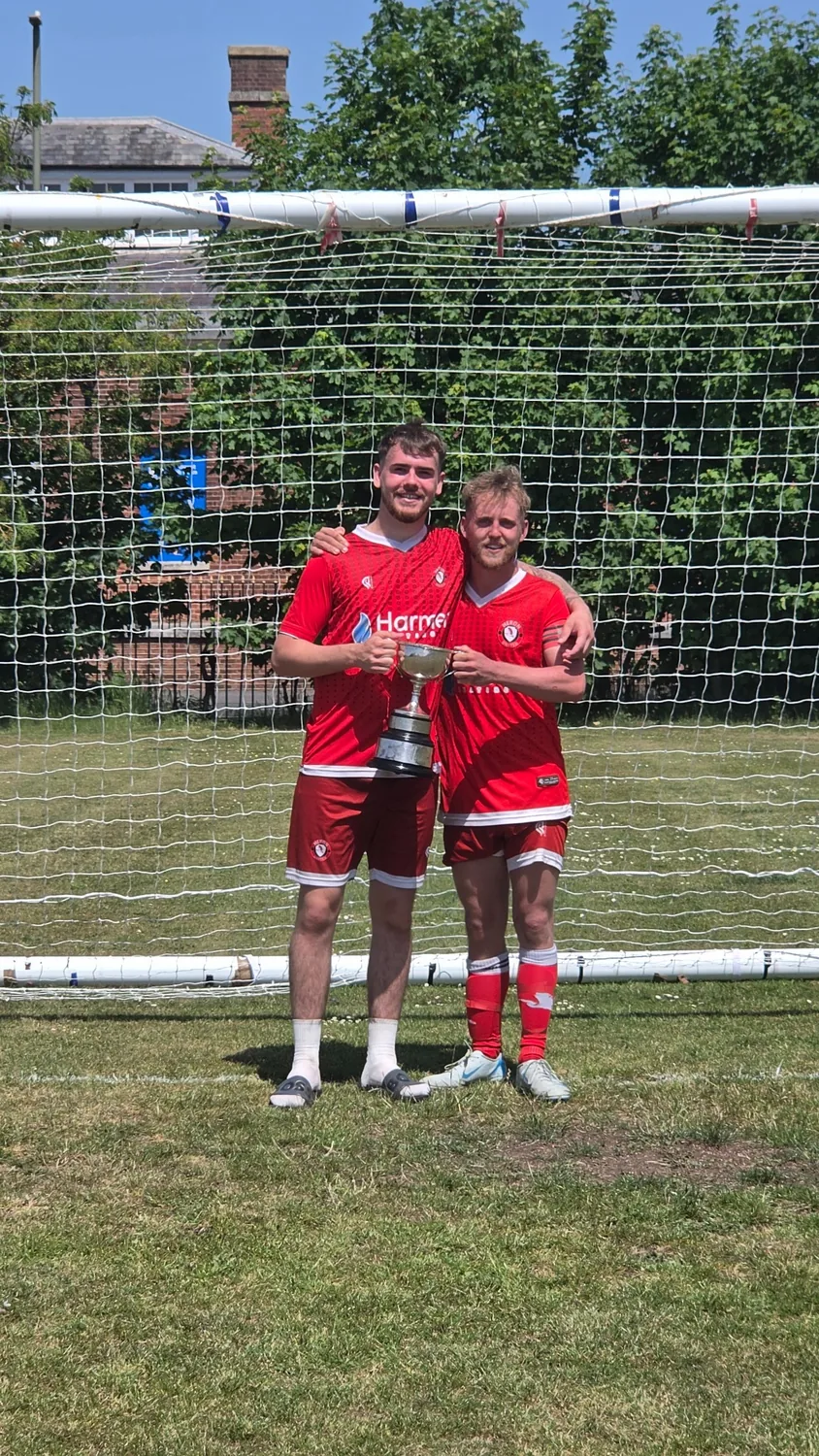 Heron United players with the trophy after winning Division 3