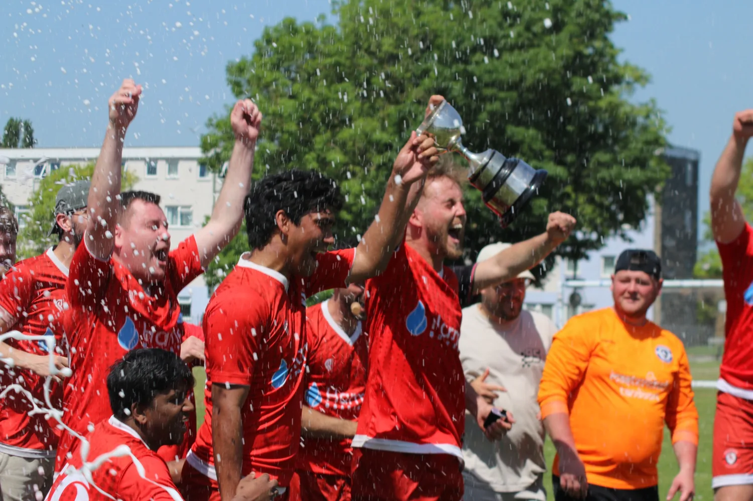 Heron United players lifting the trophy during celebrations