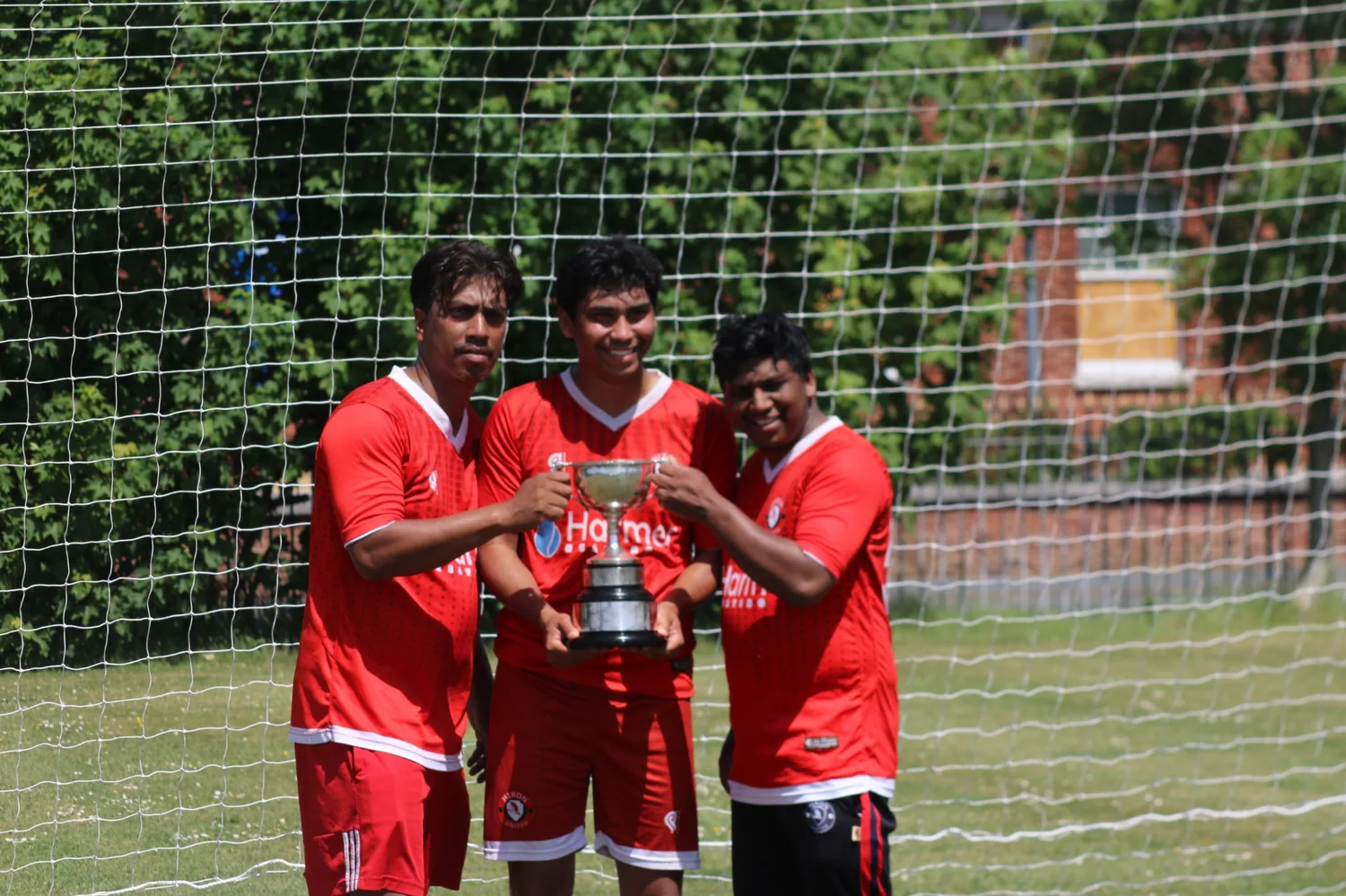 Heron United players posing with the trophy