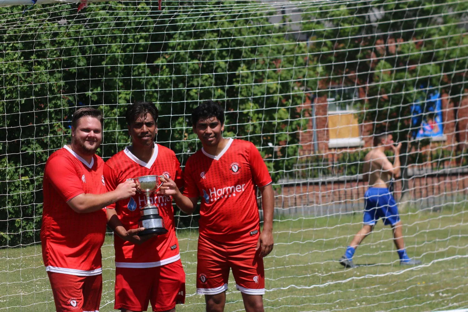 Heron United players celebrating in front of the goal